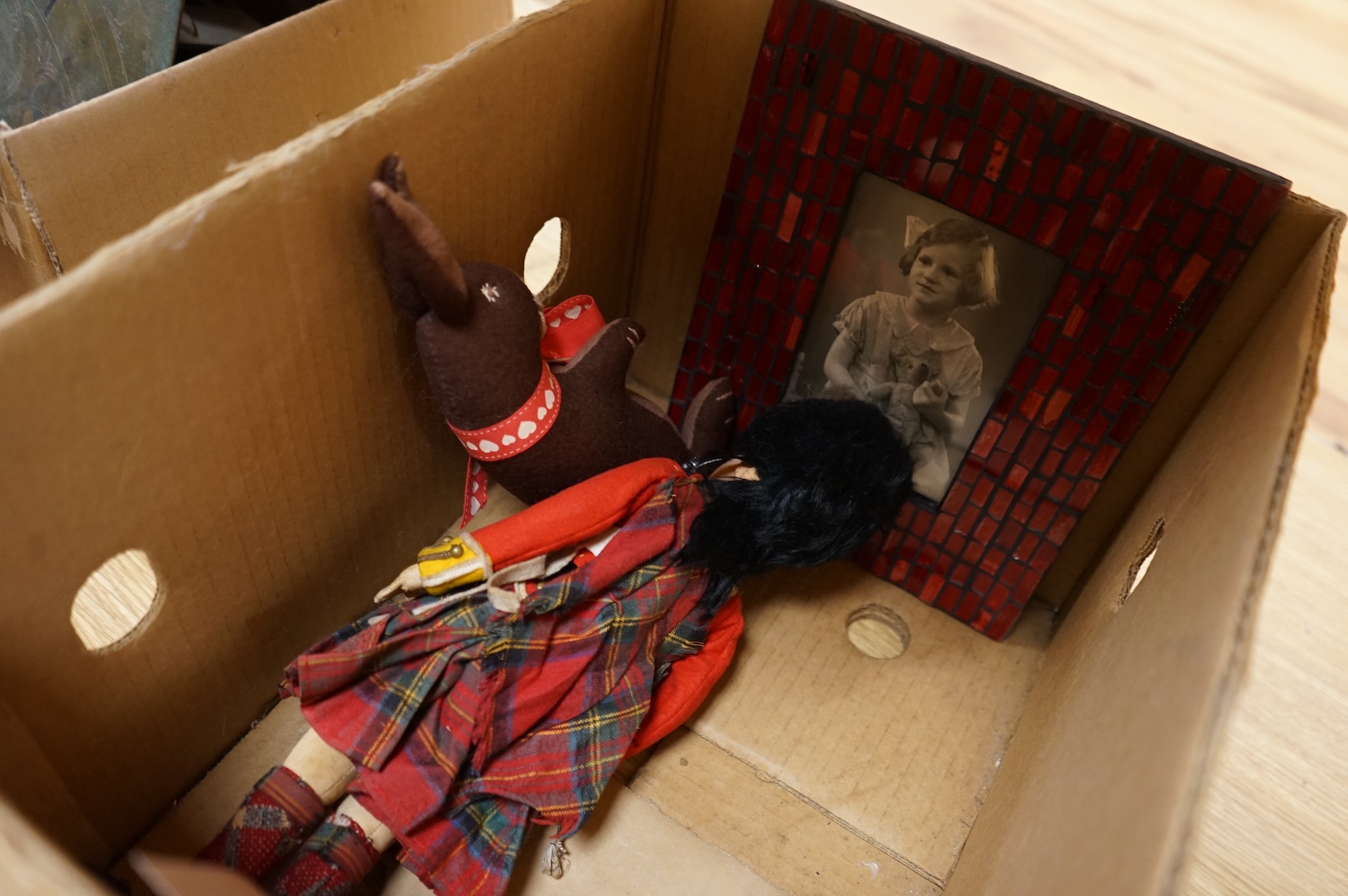 An English teddy bear and related photograph, a felt Scottish guardsman and soft toy rabbit